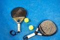 rackets paddle with two balls on blue background