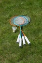 Rackets and a shuttlecock for badminton on the grass. Royalty Free Stock Photo