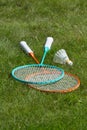 Rackets and a shuttlecock for badminton on the grass. Royalty Free Stock Photo