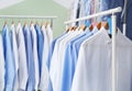 Racks with clean clothes on hangers after dry-cleaning Royalty Free Stock Photo
