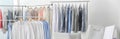 Racks with clean clothes on hangers indoors, banner design. Dry-cleaning service Royalty Free Stock Photo