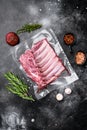 Racks of lamb meat rib fresh pack, on black dark stone table background, top view flat lay, with copy space for text Royalty Free Stock Photo