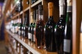 Racks with red and white wine bottles in store