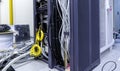 Racks with servers, computer equipment and connected twisting and coiling internet wires
