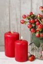 Rad candles and bouquet of hypericum plants Royalty Free Stock Photo