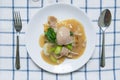 Rad Na, Famous Thai Chinese style wide rice noodle dish with tasty tender pork with thick gravy sauce. Flat lay with spoon fork