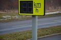 Radar to measure the speed of vehicles in the city. A reflective green sign on a pole with LED light numbers informs car drivers h
