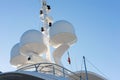 Radars on a white yacht against the blue sky. Navigation equipment, radar and antennas provide safety on board