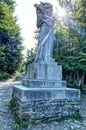 Radegast God stone statue on pedestal against sun