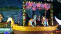 Radha Krishna Seated on Golden Color Boat on the water in Prem Mandir at Vrundavan