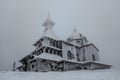 Radhost mountain with Chapel of St. Cyril and Methodius,Beskids,Czech republic.Winter landscape,foggy snowy day.Frozen wooden Royalty Free Stock Photo