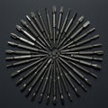 A radial arrangement of various screwdriver bits on a dark textured surface Royalty Free Stock Photo