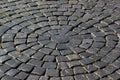 Radial pavement pattern. Background of black cobblestones