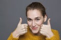 Radiant approval concept for beautiful 20s girl with thumbs up Royalty Free Stock Photo
