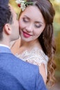 Radiant bride closes her eyes while groom kisses her cheek Royalty Free Stock Photo