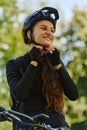 In the radiant embrace of a sunny day, a joyous girl, adorned in professional cycling gear, finds pure bliss and