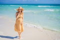 Radiant and expecting, a pregnant woman stands on a pristine snow-white tropical beach, celebrating the miracle of life