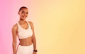 Radiant and fit young woman with a confident smile, wearing a white sports bra