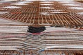 Radiant floor heating system being installed at building construction site with densely laid plastic water pipes on top of rusted Royalty Free Stock Photo