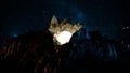 Radiant full moon rises between jagged mountain peaks under a star-filled sky, casting a luminous glow over the rugged terrain. 3d Royalty Free Stock Photo