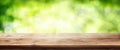 Radiant green spring background with wooden table Royalty Free Stock Photo
