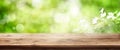 Radiant green spring background with wooden table Royalty Free Stock Photo