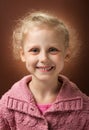 Radiant smile of little blond girl on dark Royalty Free Stock Photo