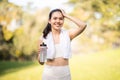 A radiant, smiling woman takes a break from her workout, holding a water bottle Royalty Free Stock Photo