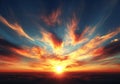 The radiant sun bursts below the clouds, set against a clear blue sky at sunset Royalty Free Stock Photo