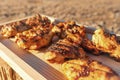 Radiant Sunlight Highlights Char-Grilled Chicken Slices on Wooden Tray, Ready to Tempt the Palate