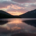 Radiant sunset casts hues of gold and pink over tranquil lake Royalty Free Stock Photo