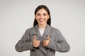 Happy businesswoman giving two thumbs up and smiling Royalty Free Stock Photo