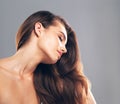 Radiantly beautiful. Studio shot of a beautiful young woman posing against a gray background.