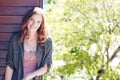 Radiantly happy. Portrait of an attractive young woman posing against a wooden wall.