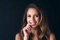 Radiating with sublime beauty. Studio portrait of an attractive young woman posing against a dark background. Royalty Free Stock Photo