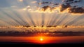 Radiating sun rays peek through scattered clouds creating a dramatic Royalty Free Stock Photo
