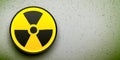 Radiation button on a grunge wall background. Nuclear alert black and yellow vector icon