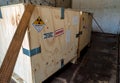 Radiation label beside the transport wooden box Type A package in the truck