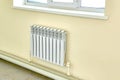 Heating white radiator under a large window Royalty Free Stock Photo