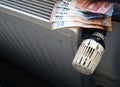 Radiator control and Euro bills on the central heating Royalty Free Stock Photo