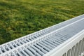 Radiator on green lawn, ecological heating concept