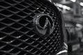 Radiator grill and Infiniti nameplate. Front side view. Luxury. Selective software focus. Shallow depth of field.