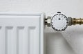 close up of white radiator thermostat in front of a white wall Royalty Free Stock Photo