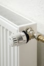 close up of white radiator thermostat in front of a white wall Royalty Free Stock Photo