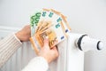 Radiator with thermostat and euro money banknotes. Royalty Free Stock Photo