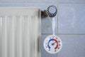 Radiator,valve and thermometer showing low temperature, shortage of heating gas due to the embargo of russian oil and gas in