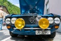 Radiator and yellow rallye headlights of an old timer blue Lancia sportscar Royalty Free Stock Photo