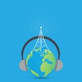 Radio antenna tower on an earth globe with headphones on blue background Royalty Free Stock Photo