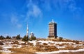 Radio antenna architecture tower and water tower on top of a snowy mountain in the Harz Mountains