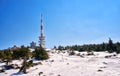 Radio antenna tower and weather station on the top of the Brocken mountain in bright winter snow landscape. Harz National Park in Royalty Free Stock Photo